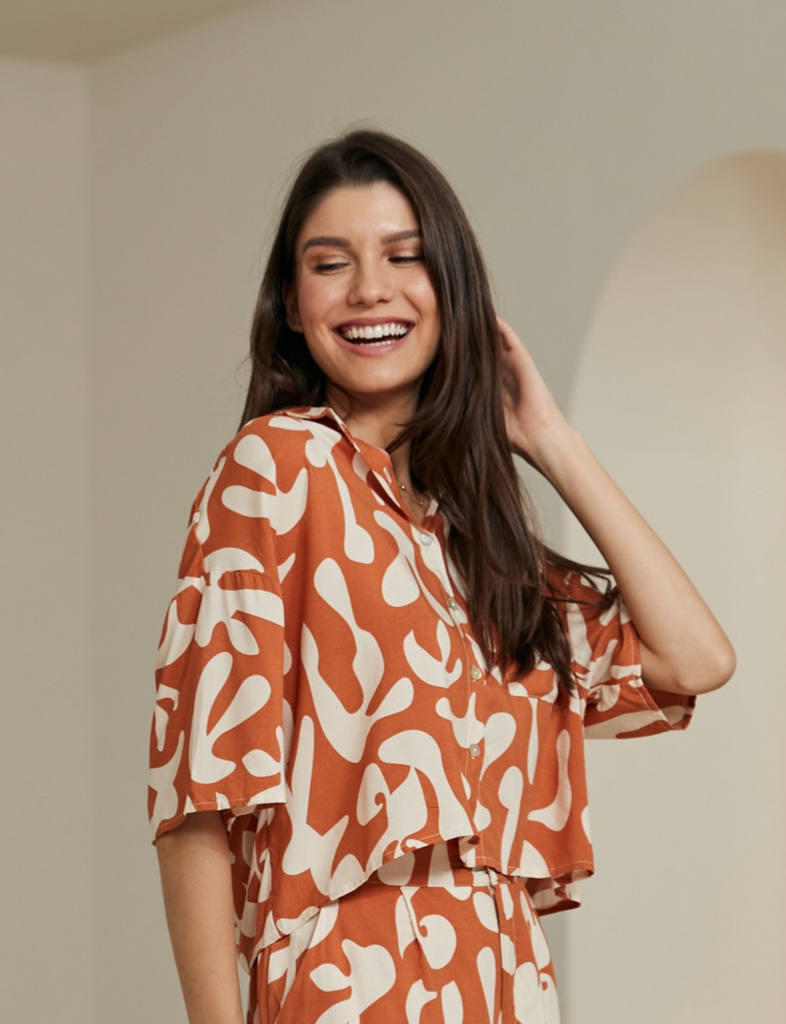 Women's orange brown rayon short sleeve shirt with a cream coral pattern